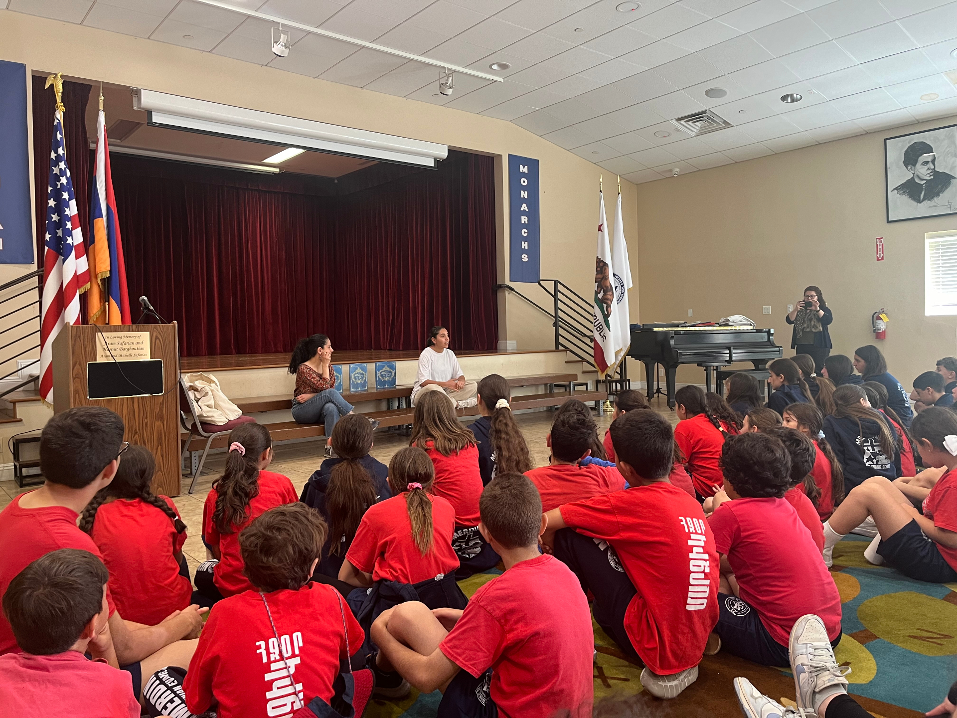Gayane speaking with students at a school assembly