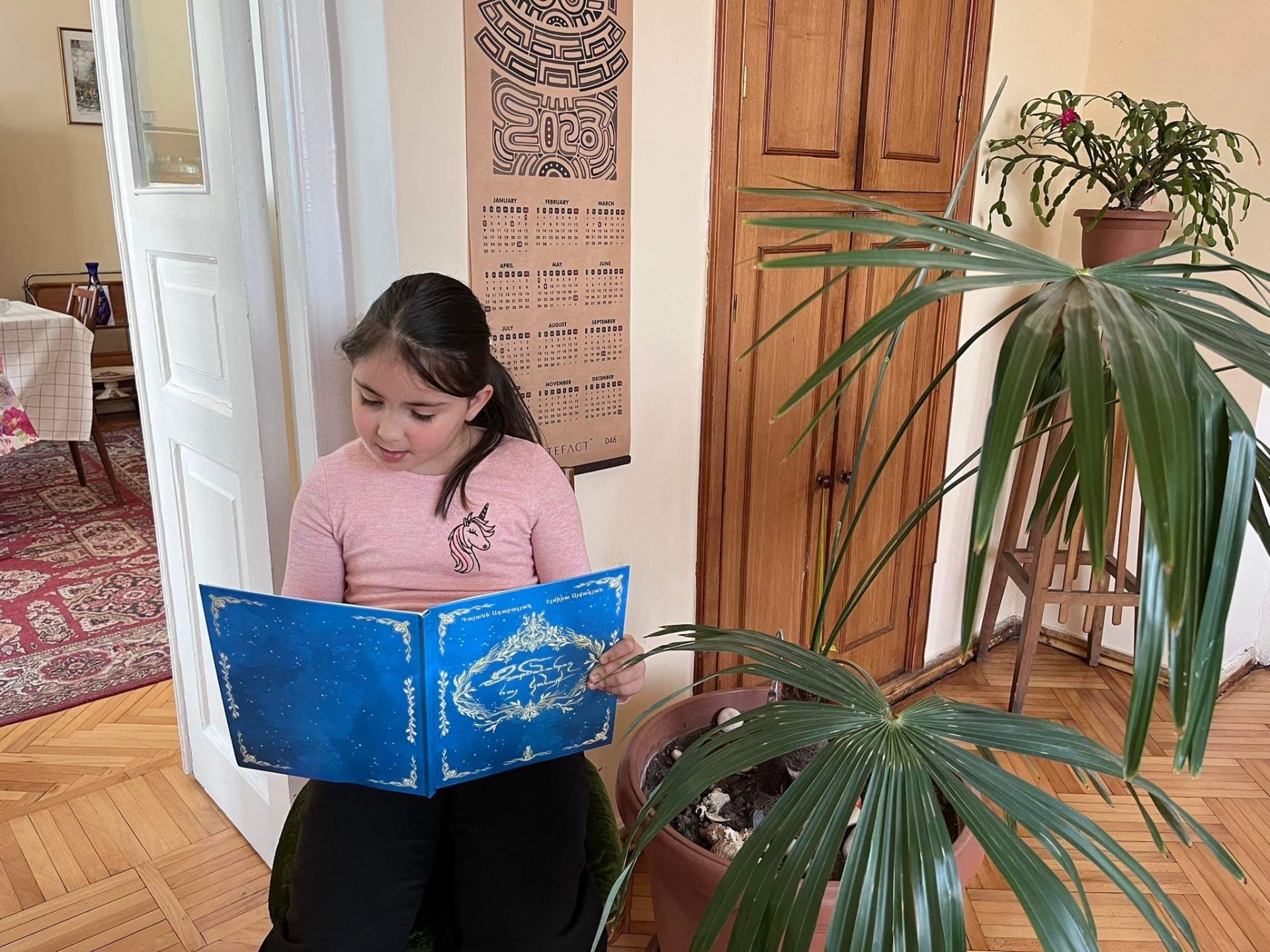 A child reading one of the books at home